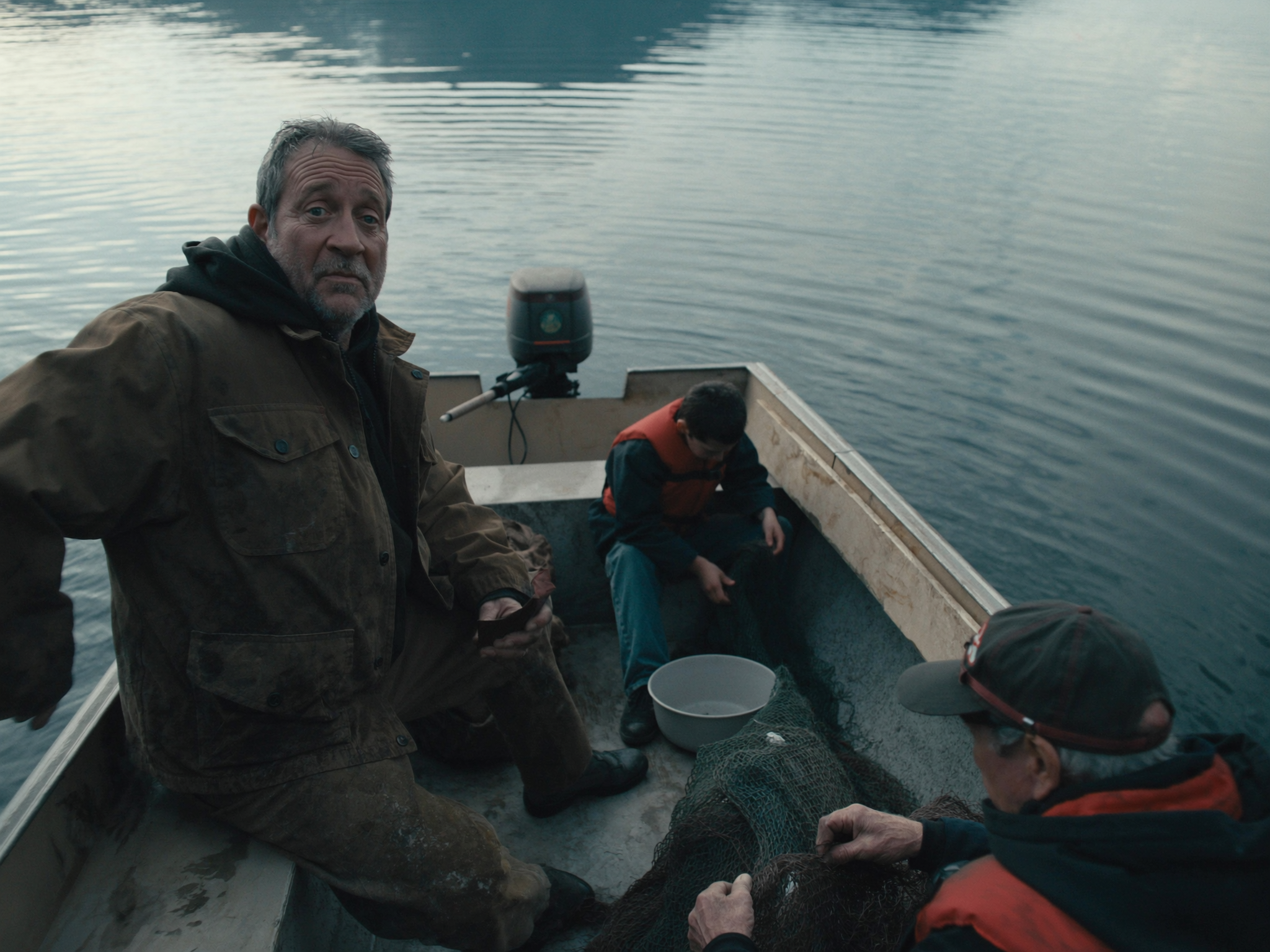 Three-generation Alaskan fishing family on setnet skiff