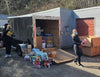 women loading up truck with lots of food and beverages for a few weeks at fish camp