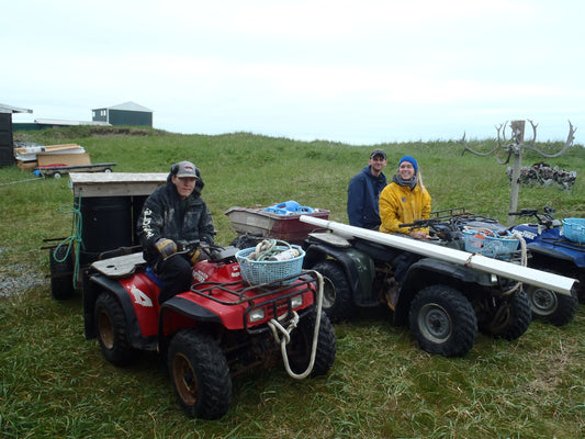 Fishers at camp preparing to trek up river to collect drinkable water from a natural spring