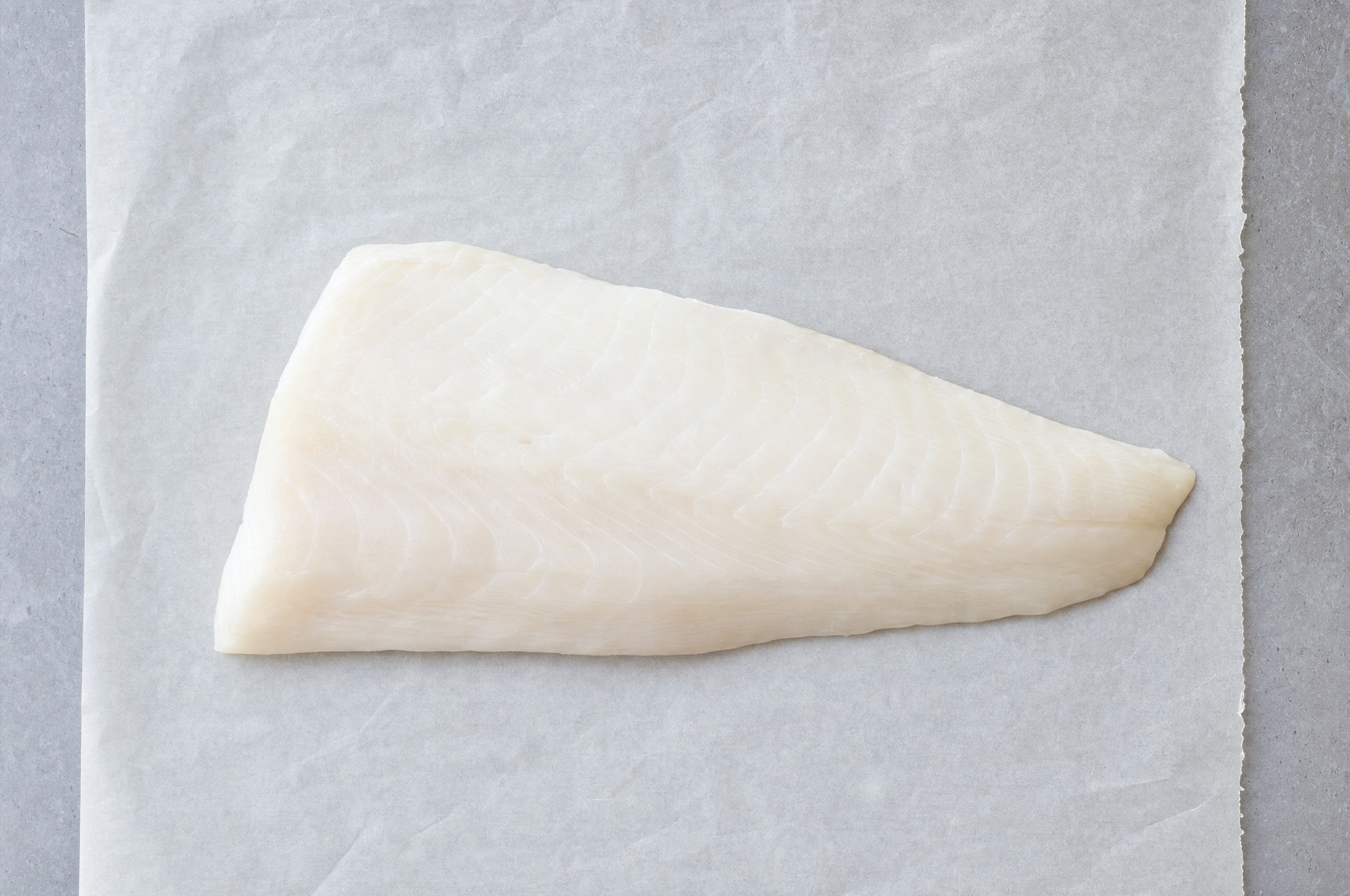 Wild Alaskan halibut white fillet on parchment