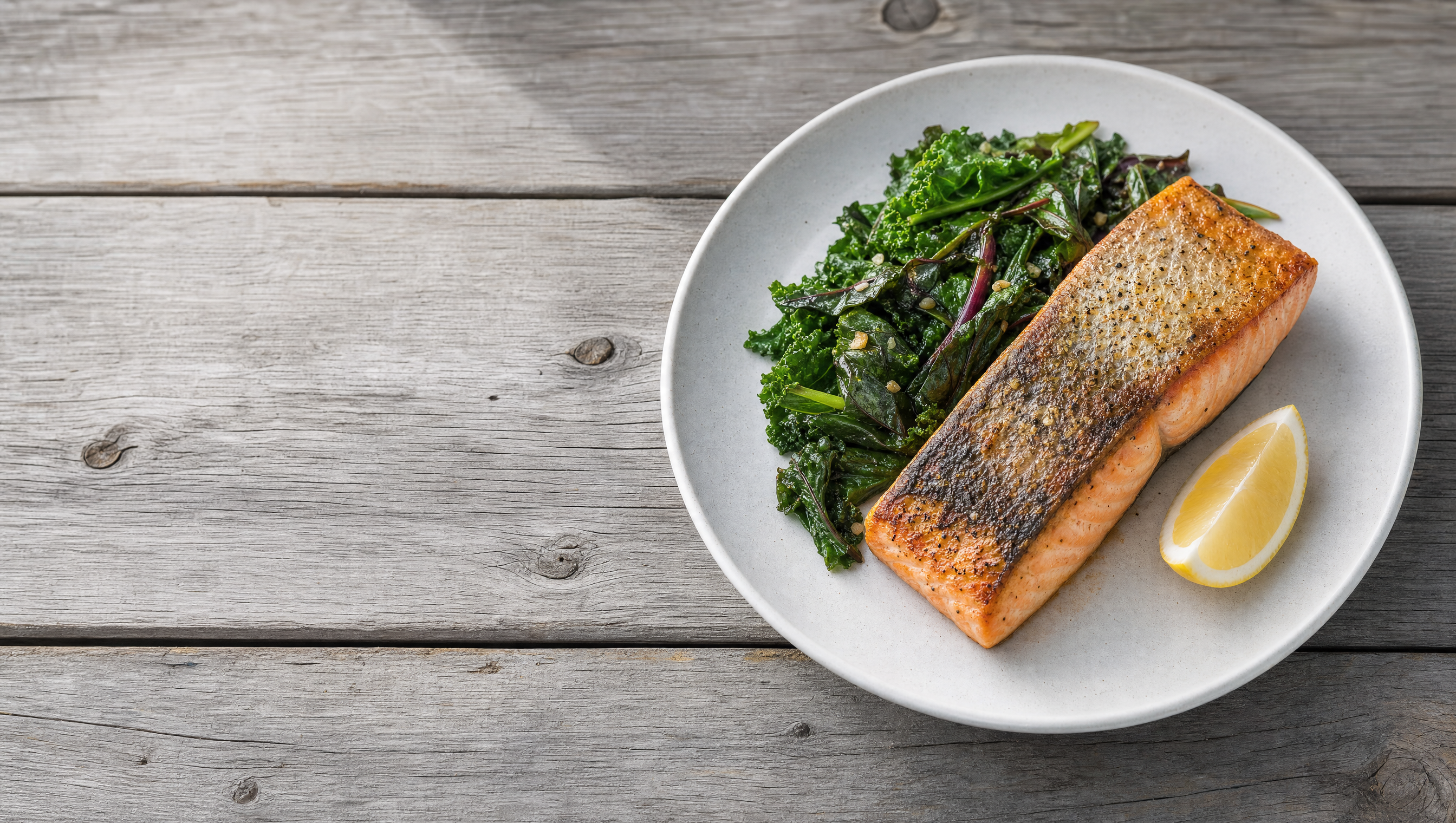 Cooked wild salmon with leafy greens